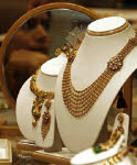 Gold down in India on rupee appreciation, up overseas